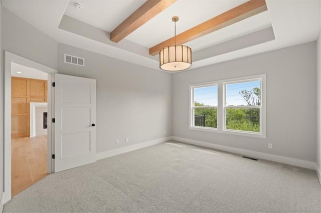 unfurnished room with beam ceiling and light colored carpet