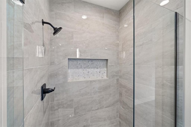 bathroom with a tile shower