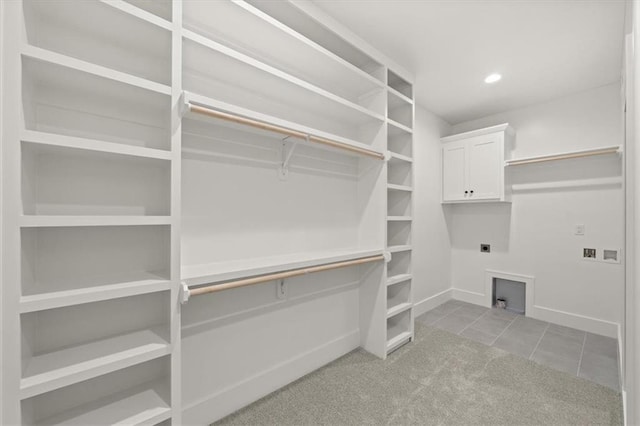 4027 NE Sagamore Dr Unit A, Lees Summit, MO 64064 - washroom with hookup for an electric dryer, washer hookup, cabinet space, tile patterned floors, and recessed lighting
