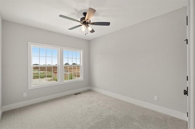 carpeted empty room featuring ceiling fan