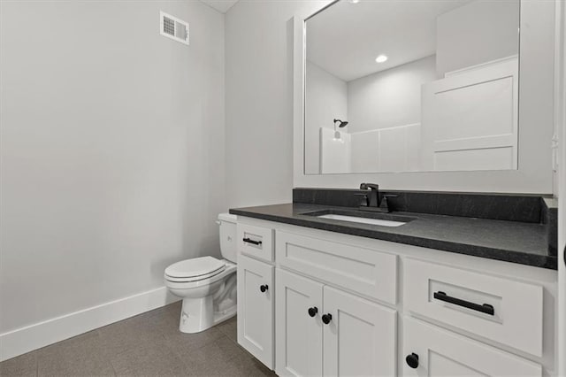 bathroom featuring vanity, toilet, and walk in shower