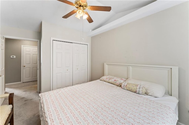 bedroom featuring carpet, a closet, vaulted ceiling, and ceiling fan