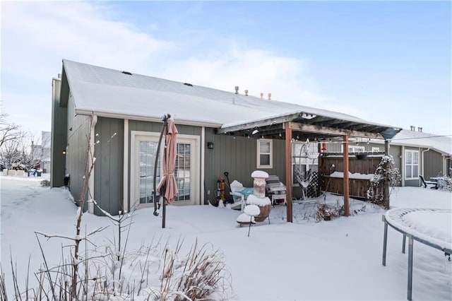 view of snow covered rear of property