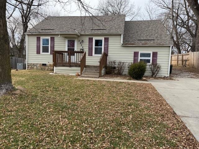 view of front of house featuring a front yard and central AC unit