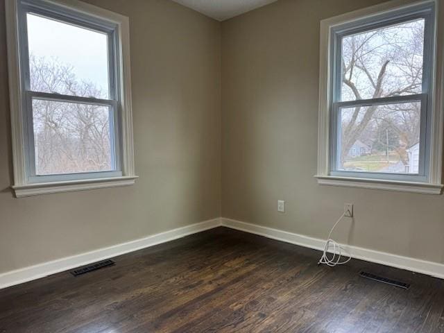 spare room featuring dark hardwood / wood-style flooring