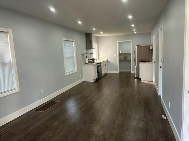 unfurnished living room featuring dark hardwood / wood-style floors and sink