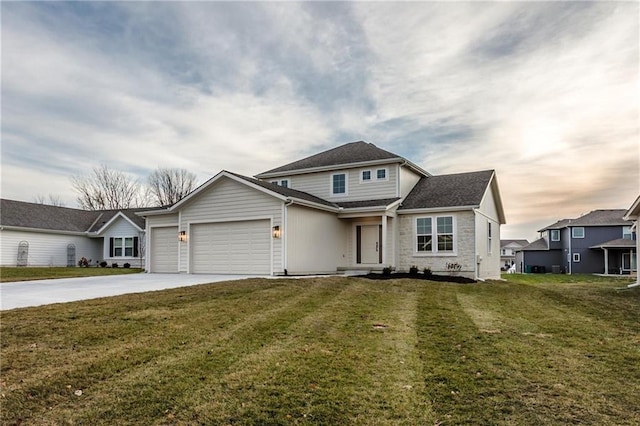 view of front of property with a garage and a lawn