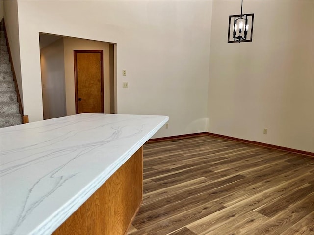 interior space featuring dark wood-type flooring and an inviting chandelier