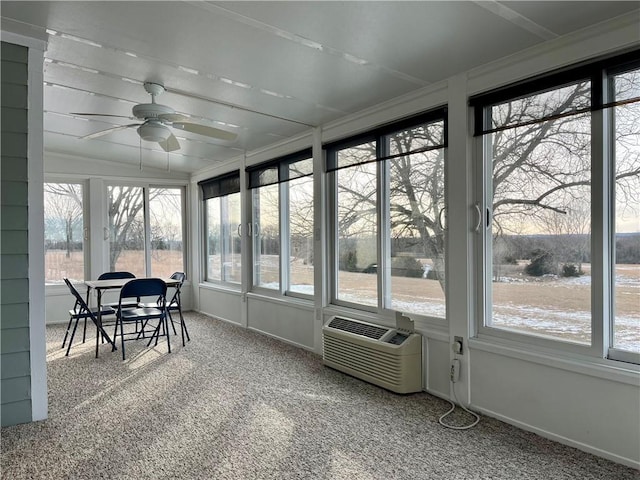 sunroom / solarium featuring plenty of natural light and ceiling fan