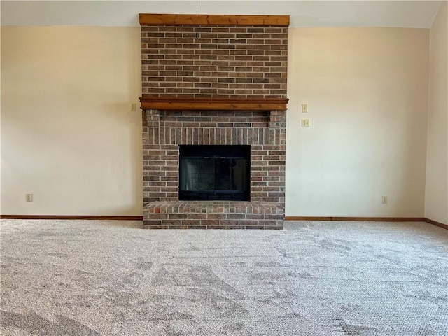 unfurnished living room featuring a fireplace and carpet floors