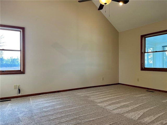 unfurnished room with ceiling fan, high vaulted ceiling, carpet floors, and a wealth of natural light