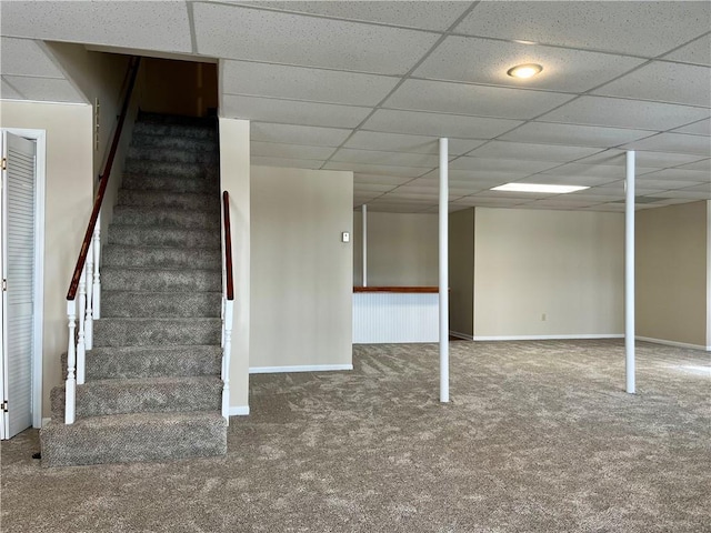 basement featuring carpet floors and a drop ceiling