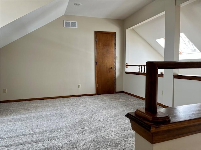 bonus room with carpet floors and vaulted ceiling