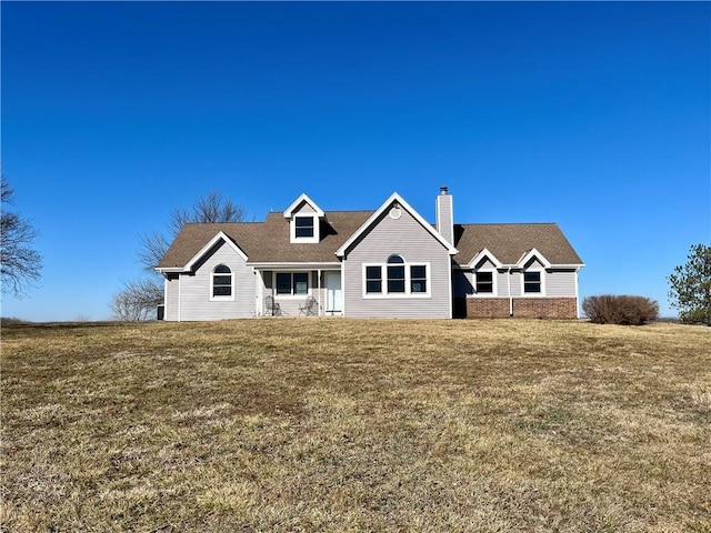 view of front of home featuring a chimney and a front yard