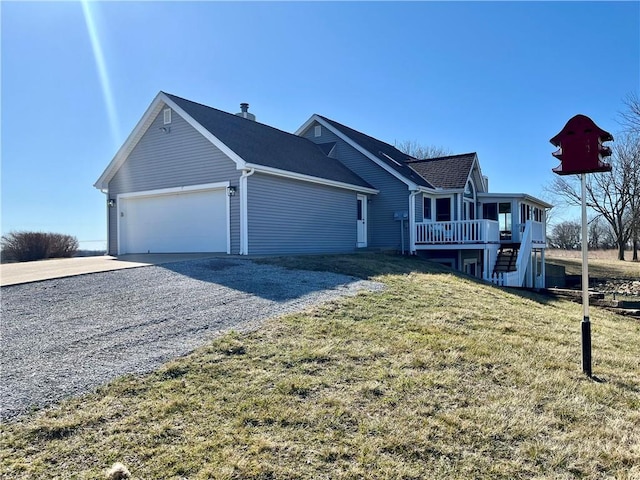 view of front facade with driveway, a front lawn, stairs, and a garage