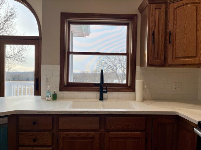 kitchen with a sink, plenty of natural light, and light countertops