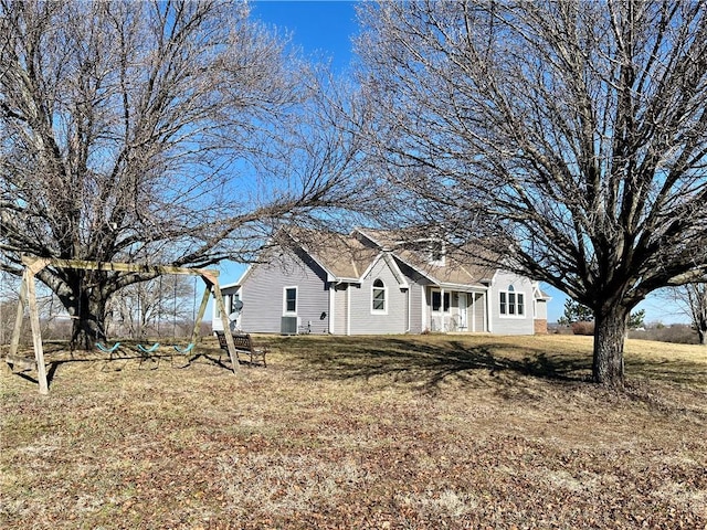 exterior space with central AC and a yard