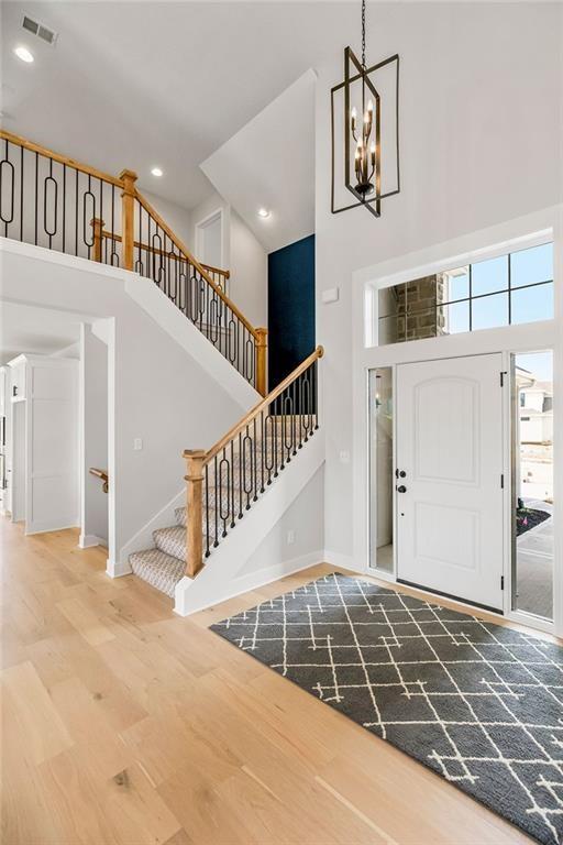 entryway featuring a chandelier, a high ceiling, and hardwood / wood-style flooring