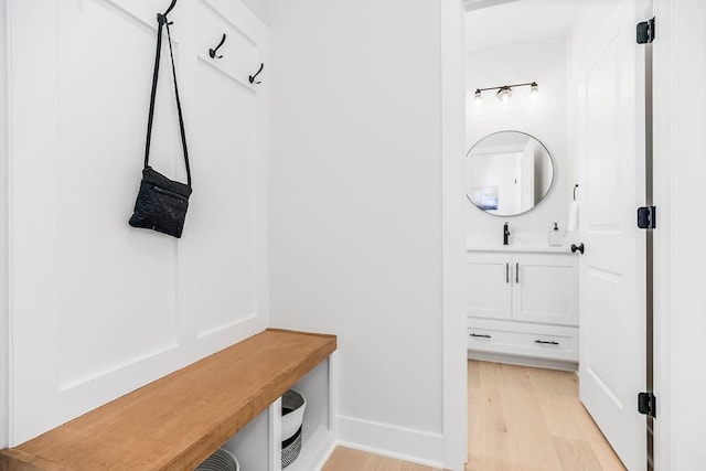 mudroom featuring sink and light hardwood / wood-style flooring