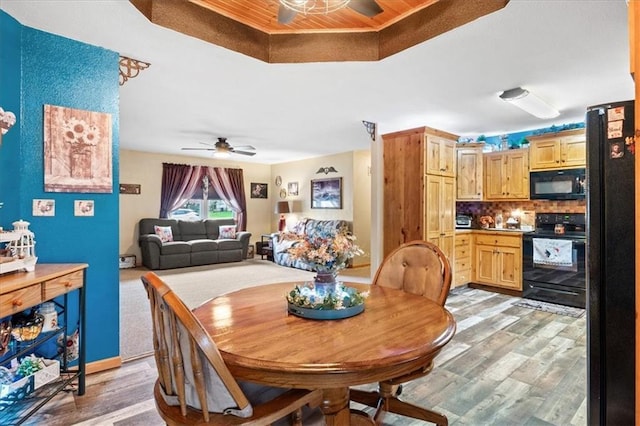 dining room with light wood-type flooring and ceiling fan