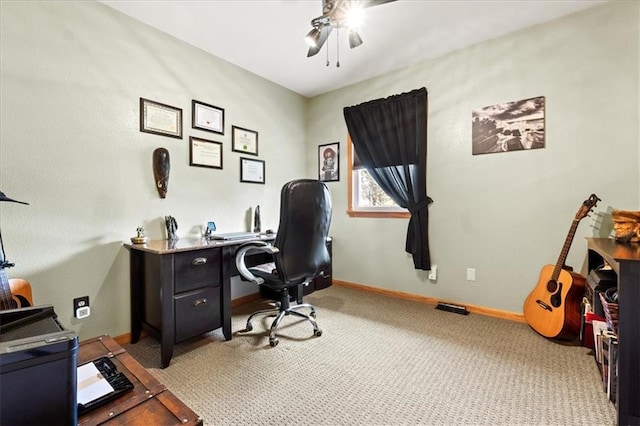 office space featuring light carpet and ceiling fan