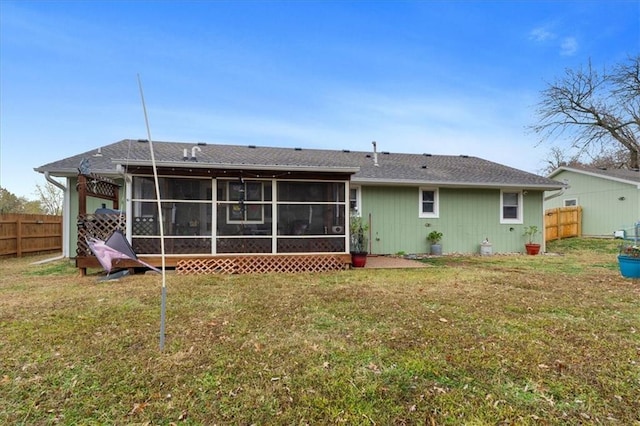 back of house with a sunroom and a yard