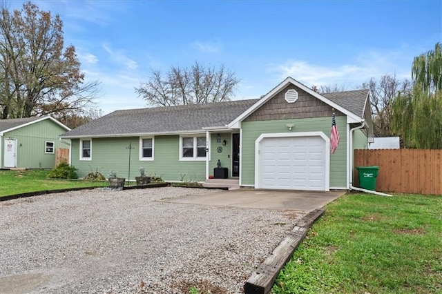 single story home featuring a garage and a front lawn