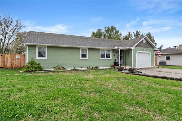 ranch-style house featuring a garage and a front yard