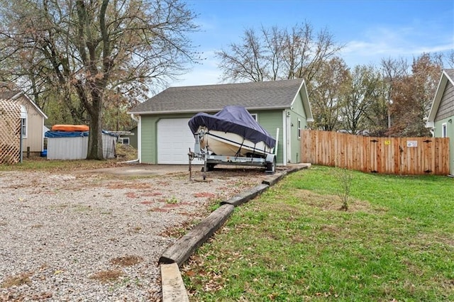 exterior space with a garage and a lawn