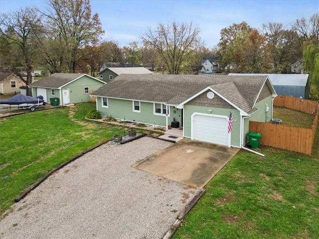 ranch-style home with a garage and a front lawn