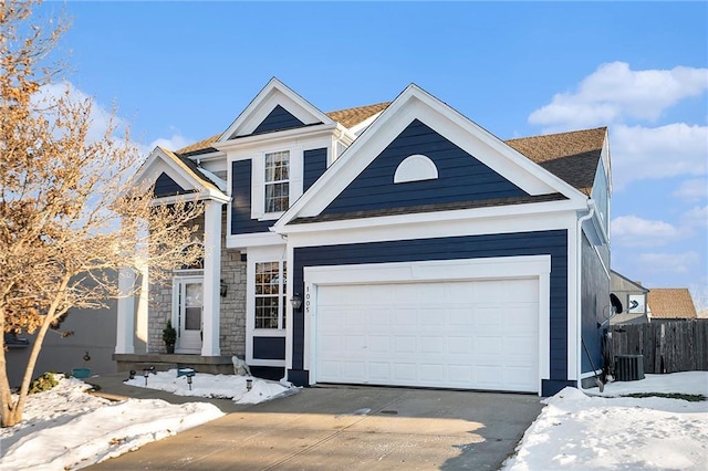 view of front of house featuring a garage and central AC unit