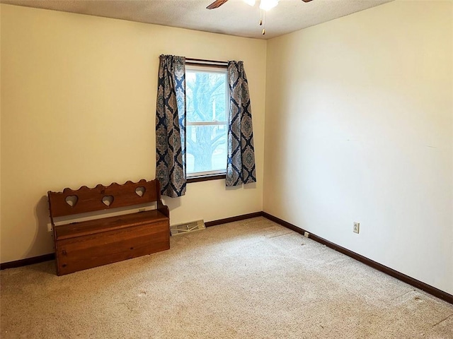 carpeted empty room with ceiling fan