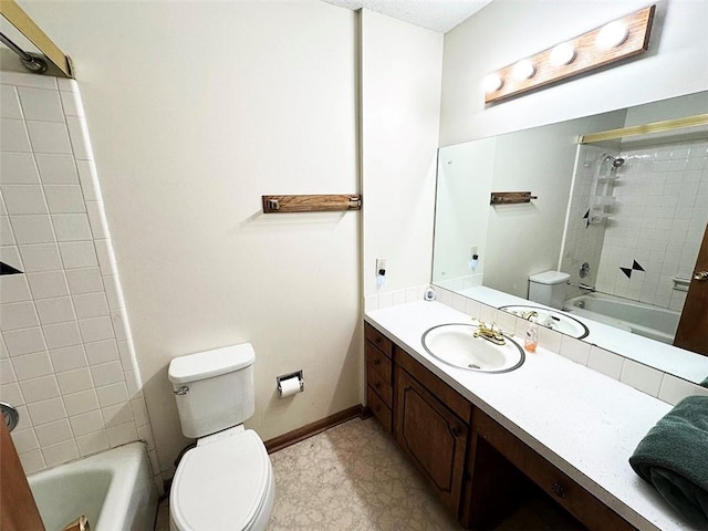 full bathroom with vanity, toilet, and tiled shower / bath combo