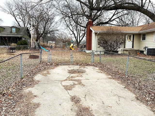 view of yard featuring a playground and central air condition unit