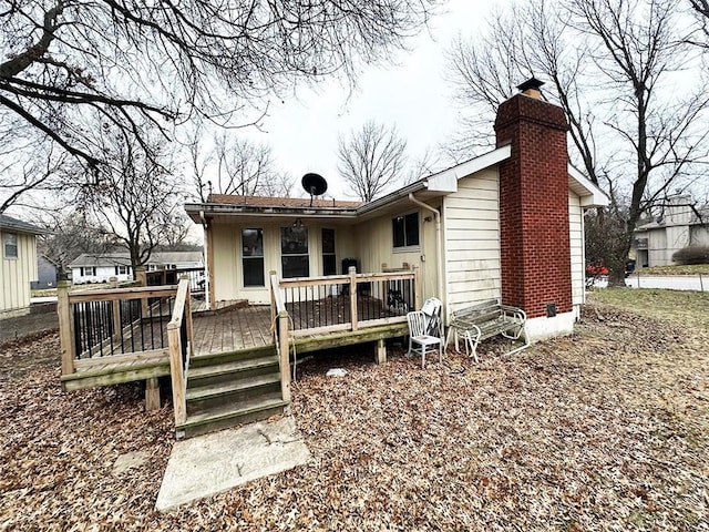 back of house featuring a wooden deck