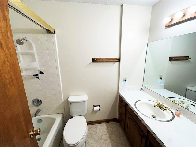 full bathroom featuring vanity, tiled shower / bath, and toilet