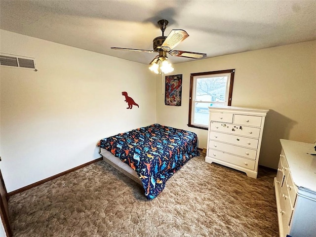 bedroom with dark colored carpet, a textured ceiling, and ceiling fan