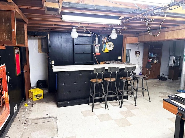 basement with electric panel and indoor bar