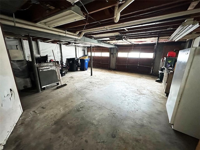 basement featuring white fridge