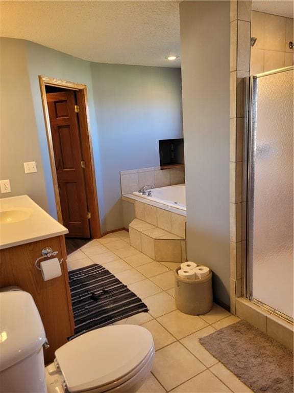 full bathroom featuring toilet, shower with separate bathtub, vanity, and tile patterned floors