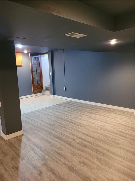 basement featuring light hardwood / wood-style floors