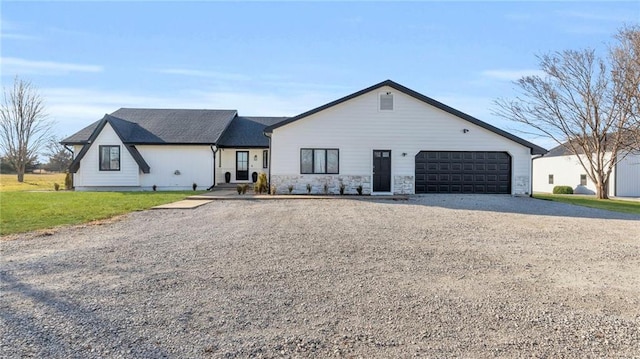 view of front of house with a garage and a front lawn