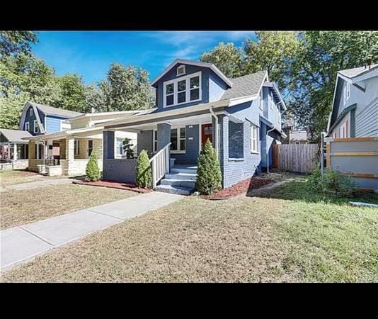 bungalow-style home featuring a front yard and a porch