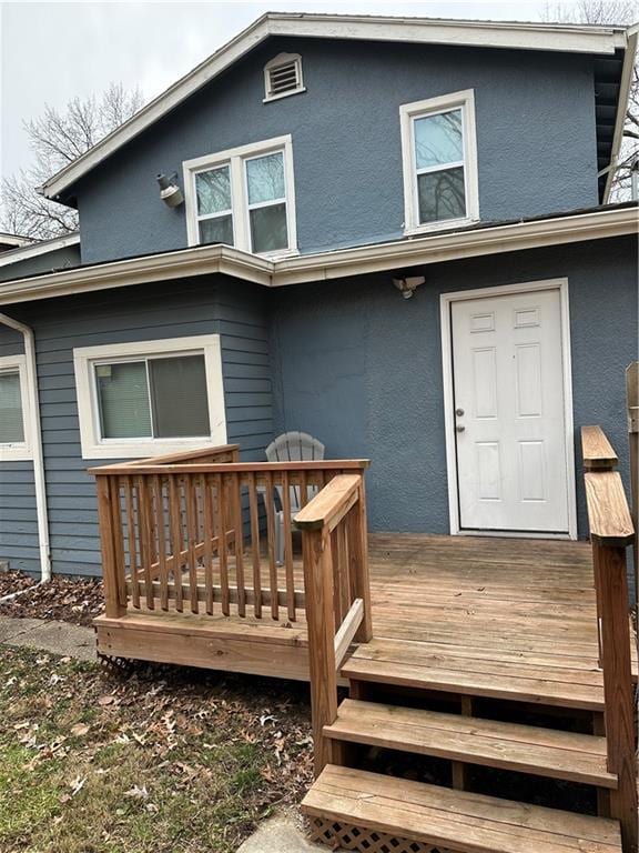 back of property featuring a wooden deck