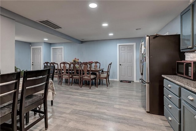 dining space featuring light wood-type flooring