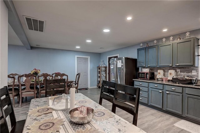 dining space with light hardwood / wood-style floors