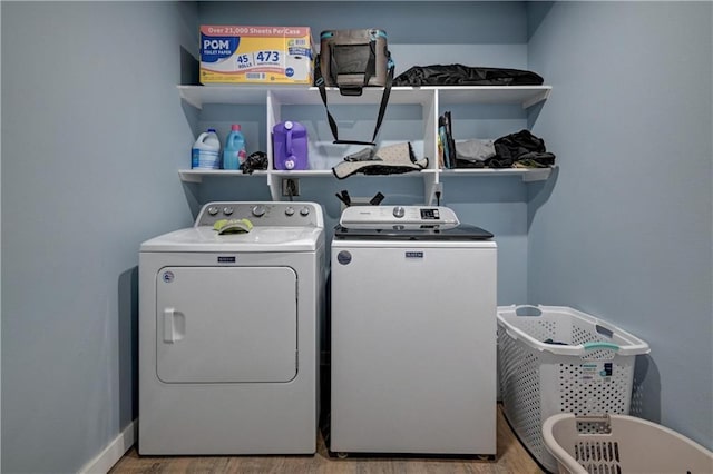 laundry area featuring washer and clothes dryer and hardwood / wood-style flooring