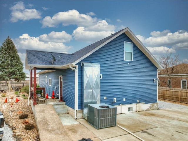 back of property with cooling unit and a patio