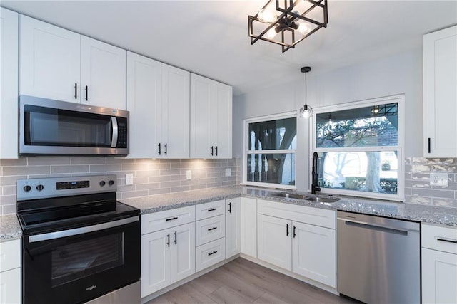 kitchen with white cabinetry, sink, and appliances with stainless steel finishes