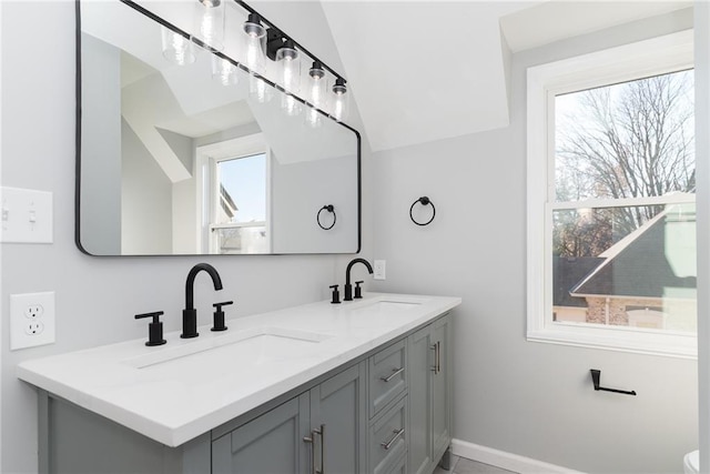 bathroom featuring vanity and vaulted ceiling